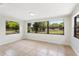 Bright bedroom features a large window, neutral paint, and tile flooring at 4415 Gilpin Way, Orlando, FL 32812