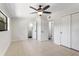 Neutral bedroom with a ceiling fan, access to bathroom, and tile floors at 4415 Gilpin Way, Orlando, FL 32812