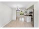 Open dining area with updated light fixture, tile floor, and view of the front yard at 4415 Gilpin Way, Orlando, FL 32812