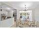 Bright dining area featuring a wooden table with seating for six, adjacent to a modern, updated kitchen at 4415 Gilpin Way, Orlando, FL 32812
