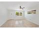 Bright, empty living room with tile flooring and a ceiling fan at 4415 Gilpin Way, Orlando, FL 32812