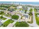 Coastal neighborhood aerial view with houses, lush greenery, and the beach in the background at 4443 Doris Dr, New Smyrna Beach, FL 32169