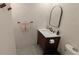 A bathroom showing a sink, toilet, towel rack, and a decorative mirror at 4443 Doris Dr, New Smyrna Beach, FL 32169