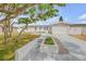 Charming single-story home featuring a well-manicured lawn, mature tree, and attached one car garage at 4443 Doris Dr, New Smyrna Beach, FL 32169