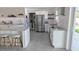 This stylish kitchen boasts stainless steel appliances, white cabinets, and a functional island with seating at 4443 Doris Dr, New Smyrna Beach, FL 32169