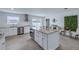 Beautiful kitchen features white cabinetry, stainless steel appliances, and a large center island with bar seating at 4443 Doris Dr, New Smyrna Beach, FL 32169