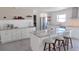 Modern kitchen features white cabinetry, stainless steel appliances, tile backsplash and a marble waterfall island at 4443 Doris Dr, New Smyrna Beach, FL 32169