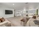 Bright, open-concept living room features tile flooring and flows seamlessly into the modern, updated kitchen at 4443 Doris Dr, New Smyrna Beach, FL 32169