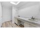 Bright bathroom featuring a double sink vanity with marble countertop and wood-look vinyl floors at 500 Newell Hill Rd # 113A, Leesburg, FL 34748