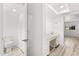 All-white bathroom featuring a toilet, sink, and a glimpse into the vinyl-floored main area at 500 Newell Hill Rd # 113A, Leesburg, FL 34748