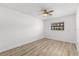 Simple bedroom with wood-look vinyl floors, a ceiling fan, and a bright window at 500 Newell Hill Rd # 113A, Leesburg, FL 34748
