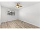 Neutral bedroom features wood-look flooring, a ceiling fan, and natural light from the window at 500 Newell Hill Rd # 113A, Leesburg, FL 34748
