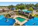 Aerial view of community pool with mature landscaping and unique architecture in a 55+ community at 500 Newell Hill Rd # 113A, Leesburg, FL 34748