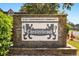 A stately brick sign for Chesterbrook, a 55+ condominium community, welcomes residents and visitors at 500 Newell Hill Rd # 113A, Leesburg, FL 34748