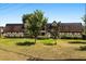 Quaint home with lush front lawn, mature trees, and charming Tudor-style accents at 500 Newell Hill Rd # 113A, Leesburg, FL 34748