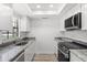 Well-lit kitchen featuring granite countertops, modern appliances, and sleek white cabinets at 500 Newell Hill Rd # 113A, Leesburg, FL 34748