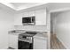 Modern kitchen featuring stainless steel appliances, granite countertops, and white cabinets at 500 Newell Hill Rd # 113A, Leesburg, FL 34748