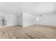 Open-concept living space with wood-look floors and a view into the updated kitchen at 500 Newell Hill Rd # 113A, Leesburg, FL 34748