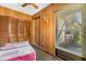 Enclosed living room featuring wood paneling and a bright window with natural light at 500 Newell Hill Rd # 113A, Leesburg, FL 34748