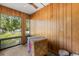 Enclosed living room with wood paneling and windows, showcasing a bright, naturally lit space at 500 Newell Hill Rd # 113A, Leesburg, FL 34748