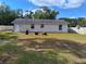 Exterior rear view showing a spacious yard, privacy fence and the back side of the house at 509 Dorothy Cir, Eustis, FL 32726
