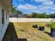 Spacious fenced backyard featuring green grass and potted plants, perfect for outdoor enjoyment at 509 Dorothy Cir, Eustis, FL 32726