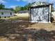 Spacious backyard with a large storage shed and a secure fence, providing privacy and extra storage space at 509 Dorothy Cir, Eustis, FL 32726