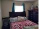 Bedroom with a zebra patterned bedspread and matching navy dresser at 509 Dorothy Cir, Eustis, FL 32726