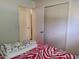 Bedroom with open closet doors and a zebra patterned bedspread at 509 Dorothy Cir, Eustis, FL 32726
