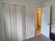 Bedroom view featuring a closet with folding doors and an open doorway to a bathroom at 509 Dorothy Cir, Eustis, FL 32726