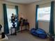 Comfortable bedroom with carpet flooring, natural light, and calming teal curtains at 509 Dorothy Cir, Eustis, FL 32726
