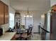 Cozy dining area with a glass table, complemented by stainless steel appliances in the adjacent kitchen at 509 Dorothy Cir, Eustis, FL 32726