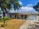 Charming single-story home with a well-maintained front yard and an attached one-car garage at 509 Dorothy Cir, Eustis, FL 32726