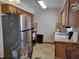 Kitchen featuring a stainless steel refrigerator and appliances, and glass dining table with wrought iron chairs at 509 Dorothy Cir, Eustis, FL 32726