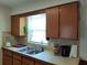 Functional kitchen featuring wood cabinets, tile backsplash, and a stainless steel sink at 509 Dorothy Cir, Eustis, FL 32726