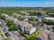 Scenic aerial view of apartment complex surrounded by lush greenery and pond at 5144 City St # 211, Orlando, FL 32839