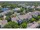 An aerial view of a residential community with multiple buildings, lush landscaping, pool, and parking spots at 5144 City St # 211, Orlando, FL 32839