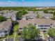 Aerial view features a community's well-kept landscaping, sidewalks, convenient parking, and charming residential buildings at 5144 City St # 211, Orlando, FL 32839