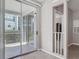 Sliding doors lead to an outdoor balcony that overlooks landscaped community grounds at 5144 City St # 211, Orlando, FL 32839