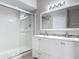 Well-lit bathroom with a glass-enclosed shower and a white double sink vanity at 5144 City St # 211, Orlando, FL 32839