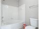 Clean bathroom showing a white tiled shower and bathtub with neutral gray walls at 5144 City St # 211, Orlando, FL 32839