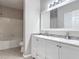 Bright bathroom featuring a double sink vanity with white cabinets and a tile backsplash at 5144 City St # 211, Orlando, FL 32839