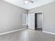 Bedroom with tile flooring, a ceiling fan, and a view into the closet through an open door at 5144 City St # 211, Orlando, FL 32839