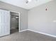 Bedroom with tile flooring, a ceiling fan, and a view into an en suite bathroom at 5144 City St # 211, Orlando, FL 32839