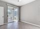 Neutral bedroom with tile flooring and sliding glass doors to an outdoor patio at 5144 City St # 211, Orlando, FL 32839
