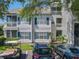 Condo exterior featuring dual screened balconies, tidy landscaping, and assigned parking at 5144 City St # 211, Orlando, FL 32839