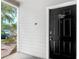 Close-up of the front door featuring a secure digital entry, and 'welcome' sign at 5144 City St # 211, Orlando, FL 32839