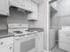 Bright kitchen offers modern appliances and leads to a convenient laundry area at 5144 City St # 211, Orlando, FL 32839