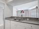 A kitchen sink and breakfast bar provide views into a neutrally decorated living space at 5144 City St # 211, Orlando, FL 32839