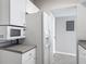 Clean, well-maintained kitchen with microwave, refrigerator, and easy access to laundry room at 5144 City St # 211, Orlando, FL 32839